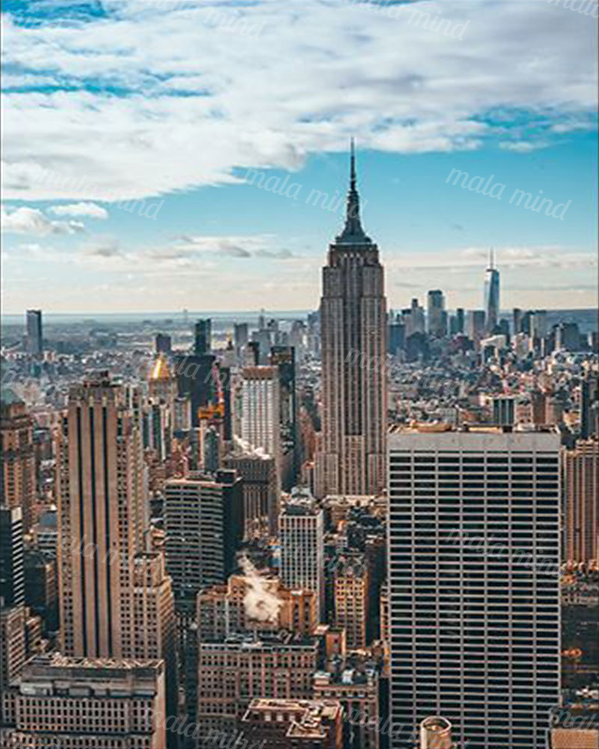 Aerial Manhattan skyline with the Empire State Building centered beneath a blue, cloud-filled sky — 02_master_artwork